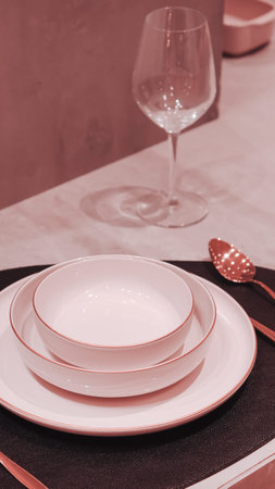 Table setting with plates and wine glasses. Selective focus. Toned.