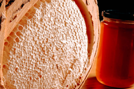 Honey in a jar on a wooden table. Close-up.の写真素材