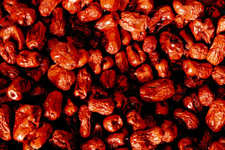 Dried red hot chili peppers on a black background. Toned.