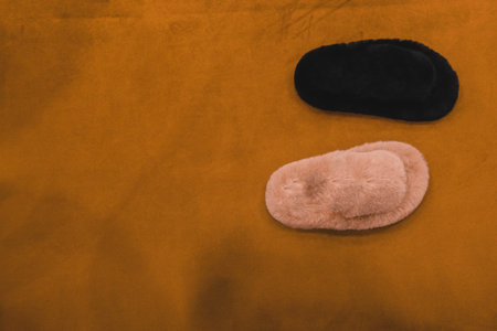 Pair of fur mittens on orange background.の写真素材