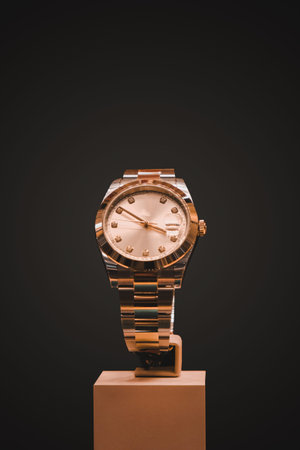 Luxury wristwatch on stand isolated on black background with clipping path