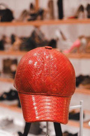 Red cap on a stand in a shoe store.