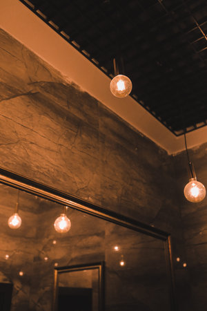 Light bulbs hanging on the ceiling in the cafe. Retro style.