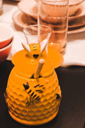 Ceramic teapot with drinking straws on a table
