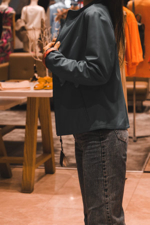 Close up of a woman wearing a jacket in a fashion store