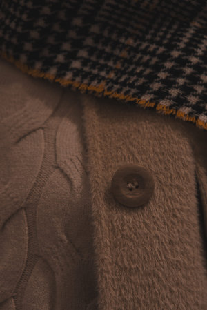 Close up detail of a brown wool coat with a buttonhole.