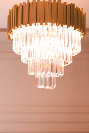 Chrystal chandelier hanging on the ceiling in the room