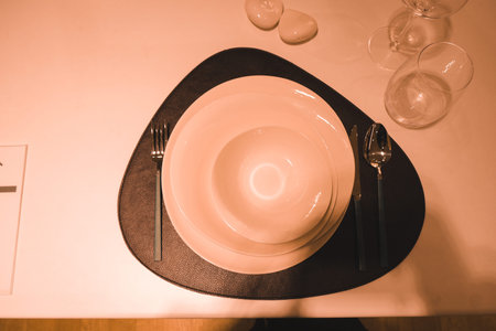 Table setting with plates, cutlery and napkins in restaurant