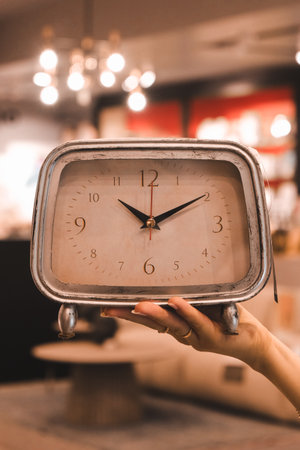 cropped shot of person holding alarm clock, blurred backgroundの写真素材