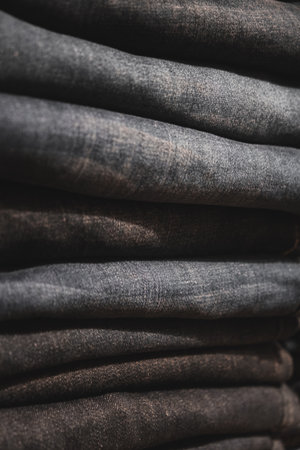 Jeans stacked in a row. Selective focus. Toned.の写真素材