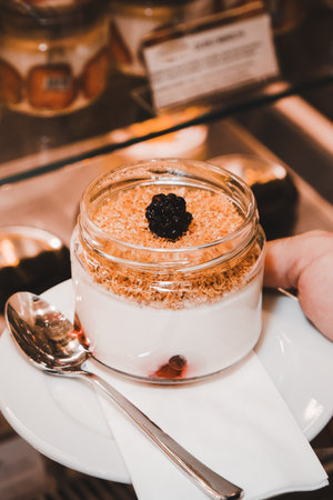 Closeup of delicious tiramisu dessert in glass jar on tableの写真素材