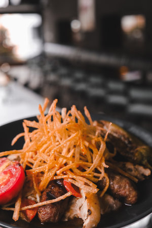 A sizzling hot plate of perfectly cooked meatの写真素材