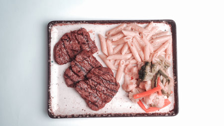 A sizzling hot plate of perfectly cooked meatの写真素材