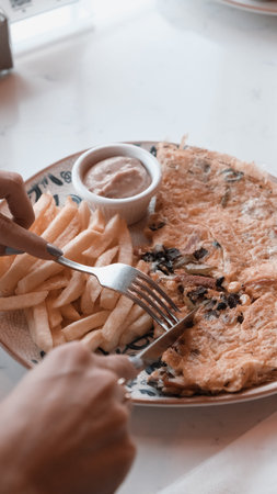 Delicious omelette and breakfast plate on the table.