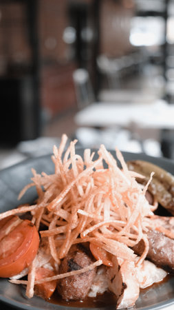 Salad with meat, tomato and onion on the plate in restaurantの写真素材