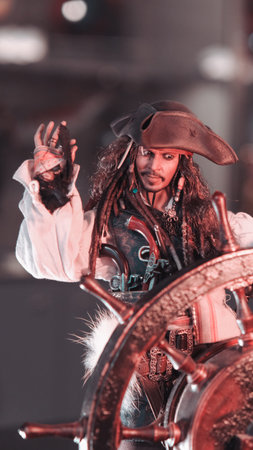 beautiful african american woman in pirate costume holding steering wheel