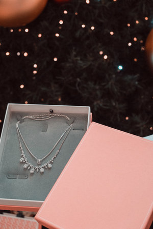 jewelry box with a necklace on the background of a Christmas tree