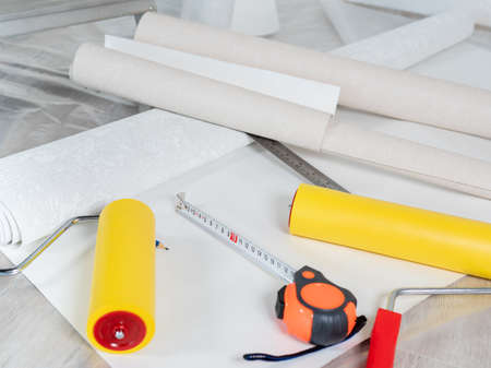 The concept of repair in the apartment of wallpapering the walls. Tools for the process of wallpapering in the apartment.の写真素材