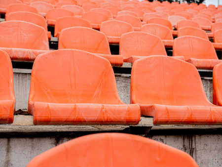 Empty seats in a sports stadium. Lack of spectators at the stadium during the pandemic.の写真素材