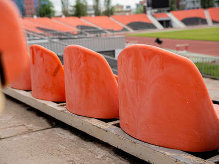 Lonely empty seats for fans in a sports stadium.の写真素材