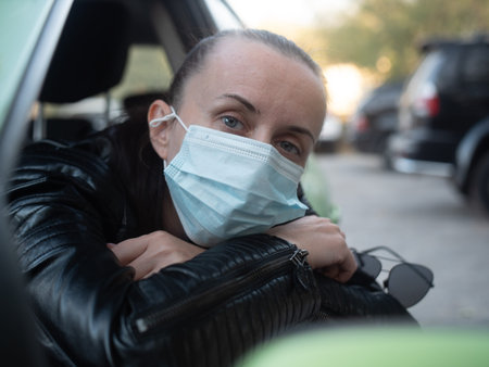 Portrait of a woman in a car near the window close-up, sad. Sad face in the car. Concept -...