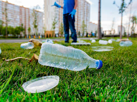 plastic trash on the green lawn in the park. Environmental pollutionの写真素材