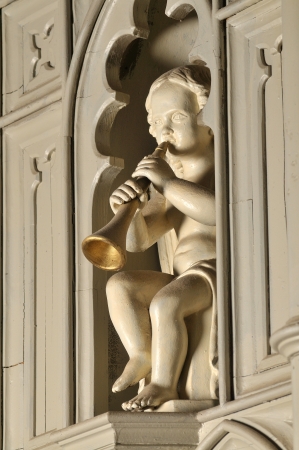 wooden angel plays trumpetの写真素材