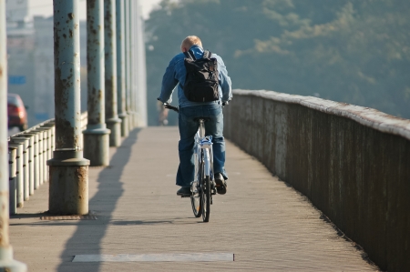 Biking in the city without a helmetの写真素材