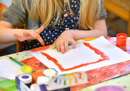 Girl painting with finger