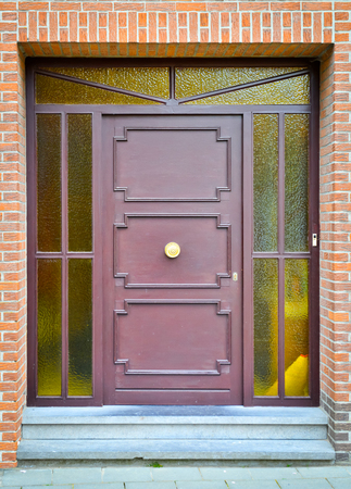 Violet wooden front door with yellow glass windowsの写真素材