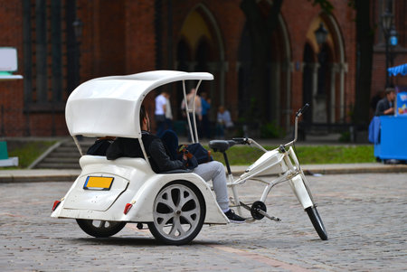 White cycle rickshaw on street of Riga