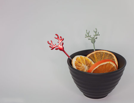 dried orange in a black bowl with antlersの写真素材
