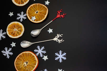 Christmas candy with red deer, white snowflake on black background. Christmas background. Top view and copy space.の写真素材