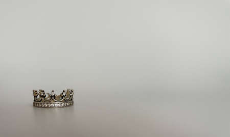 Ring in the form of a crown on a gray backgroundの写真素材