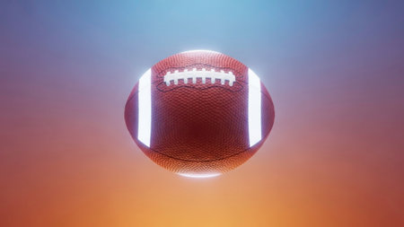 American football ball against orange and blue background with vignette effectの素材