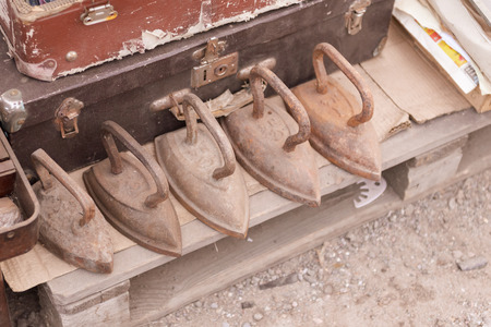 Flea market. Sale of old things. Irons for all occasions.の写真素材