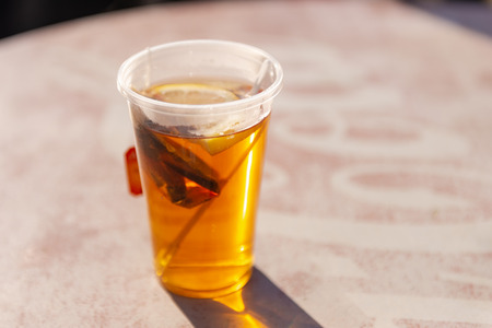 Tea. A glass of tea with lemon. Reflection of the sun in a glass of tea.の写真素材