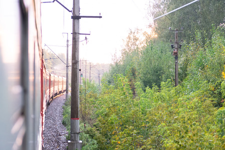 An electric locomotive. The train takes me in the morning. Railway tracks curve.の写真素材