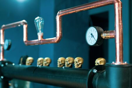 Copper pipe with barometer and skulls.の写真素材