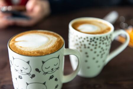 Beautiful coffee in cute mugs. Delicious coffee in the cafe.の写真素材