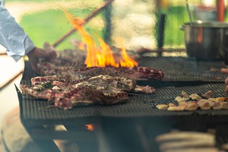The meat on the grill. Cooking meat by Italian cooks. Meat festival in Tuscany. May 2019.の写真素材