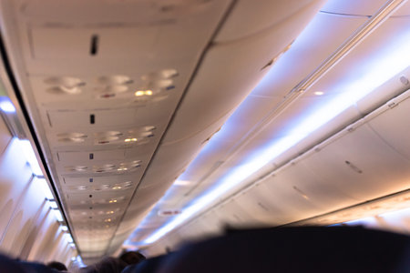 The cabin of the passenger aircraft. Airliner ceiling light.