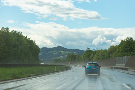 Roads Of Austria. Austrian highway with beautiful views. Wet road after rain. Photo from the car.のeditorial素材