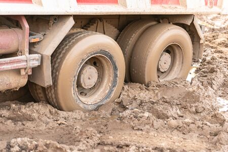 Stuck truck. The rear wheels are muddy. Blurred primer.の写真素材
