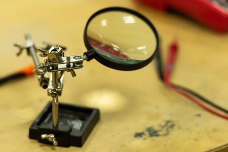 Magnifier. Tool for precise soldering. Magnifying glass in the electronics repair shop.の写真素材