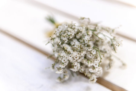 A small bouquet of dried flowers. Preserved beauty. Small bouquets on a white bench.