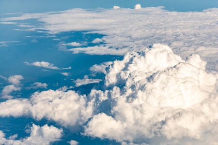 Clouds from the plane window. Beautiful sky and sea of clouds, photo from above. Various forms of cloud cover.の写真素材