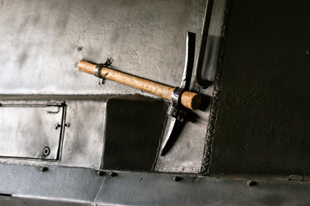 Military equipment of the second world war. Ice axe on the wall of the tank. Additional tool on the...