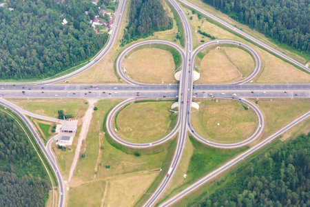 Road interchanges in the Moscow region. Cloverleaf overpass. View from the plane window.