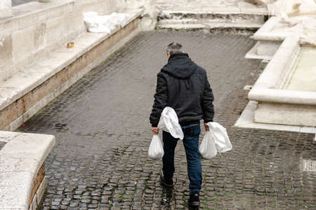 Rome, Italy. Winter 2020. Cleaning the Trevi Fountain from coins. Pumping out coins with a special vacuum cleanerのeditorial素材
